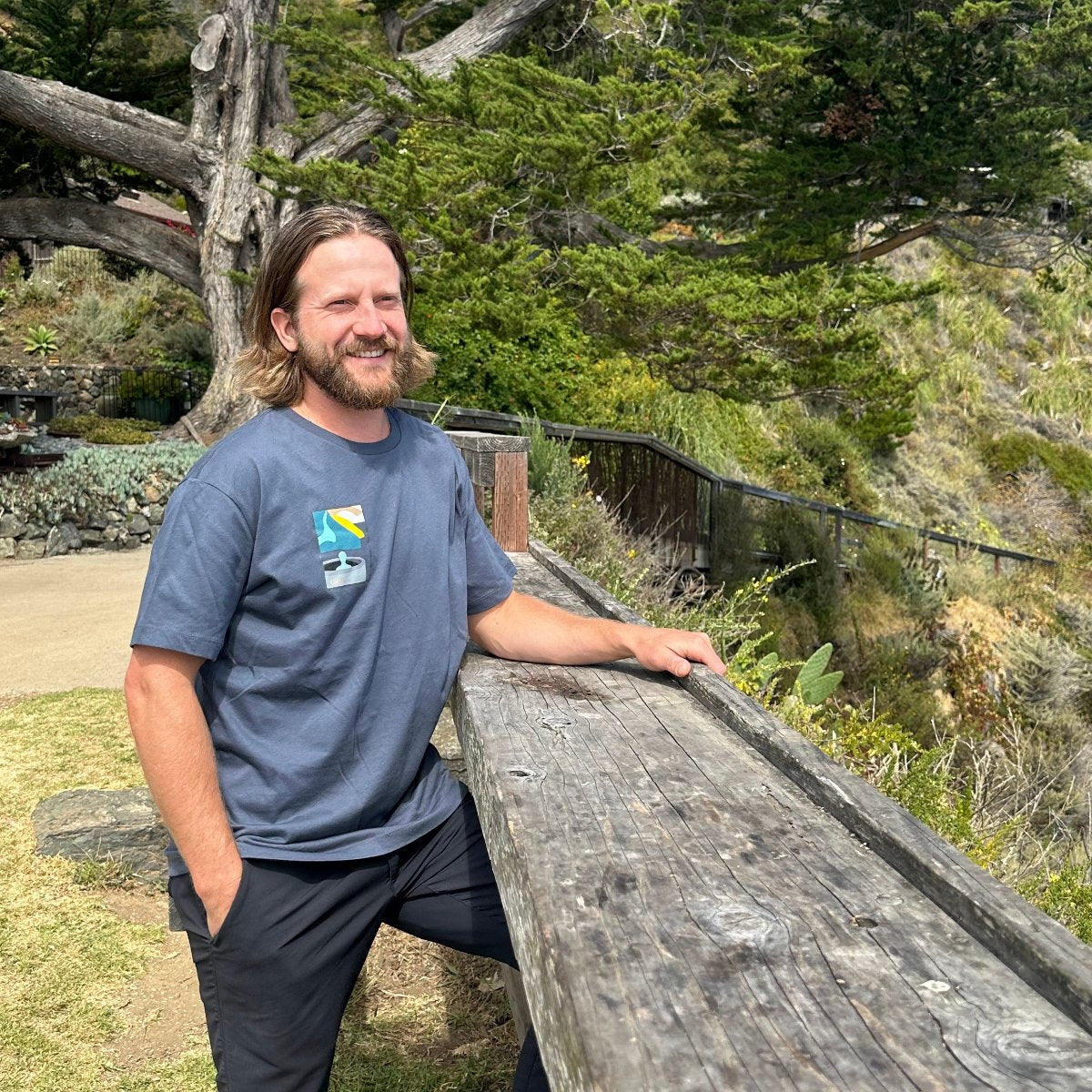 Esalen Apparel & Accessories - Esalen Baths View w/Tan Cliffside T-Shirt in Light Navy on staff member
