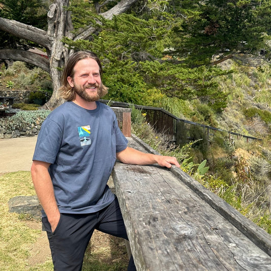 Esalen Apparel & Accessories - Esalen Baths View w/Tan Cliffside T-Shirt in Light Navy on staff member