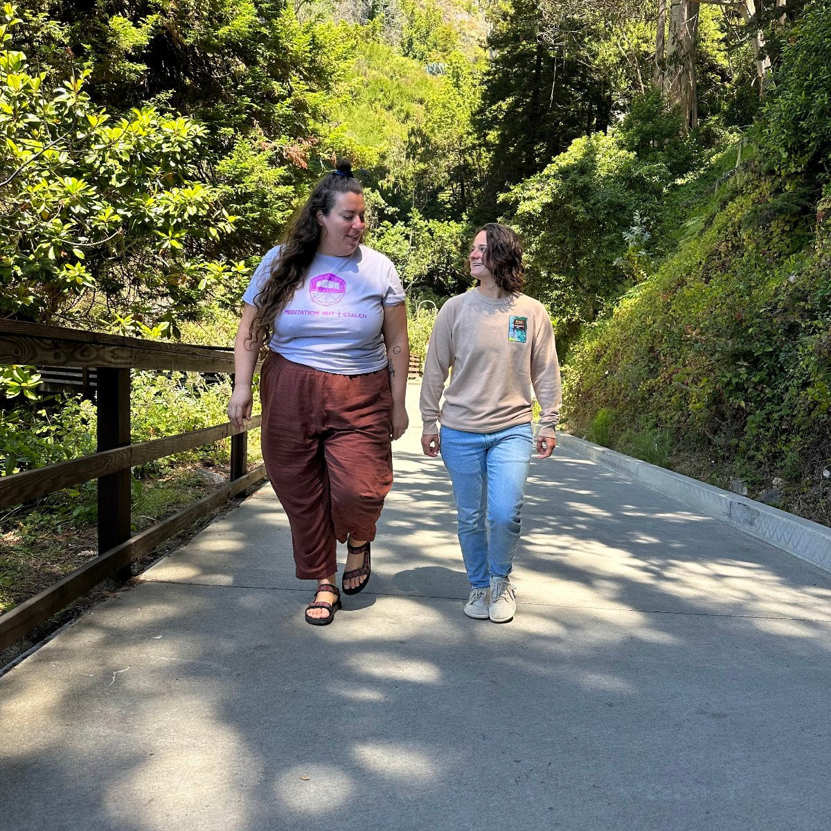 Esalen Apparel & Accessories - Esalen Embroidered Reservations Only Sweatshirt in Tan on staff member walking with friend